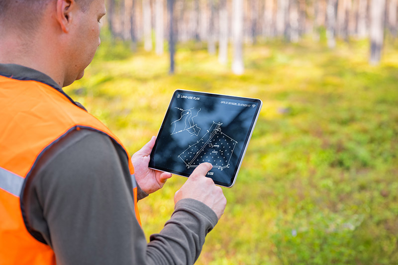 Landscape Engineer Locating Plot Using Tablet Device